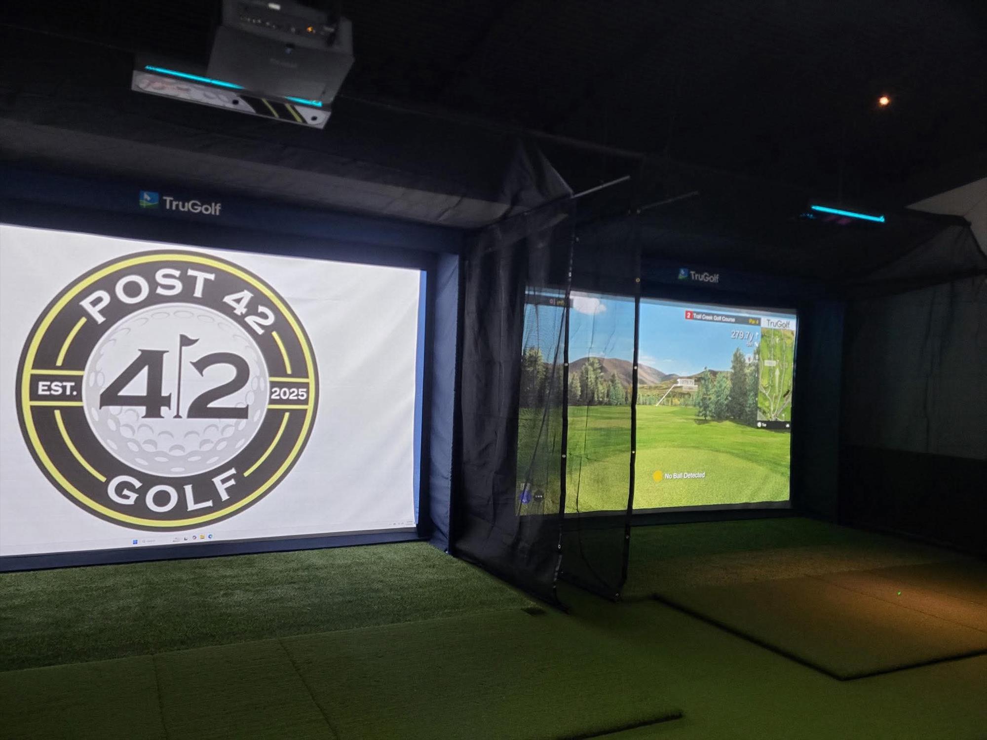 TruGolf simulator bays with Post 42 Golf logo and virtual course display