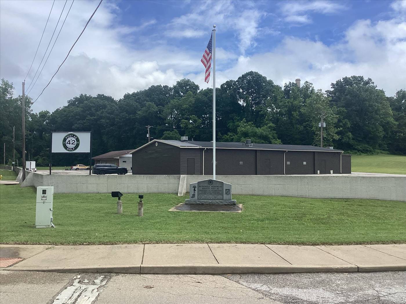 Post 42 Golf building exterior with American flag and veterans memorial